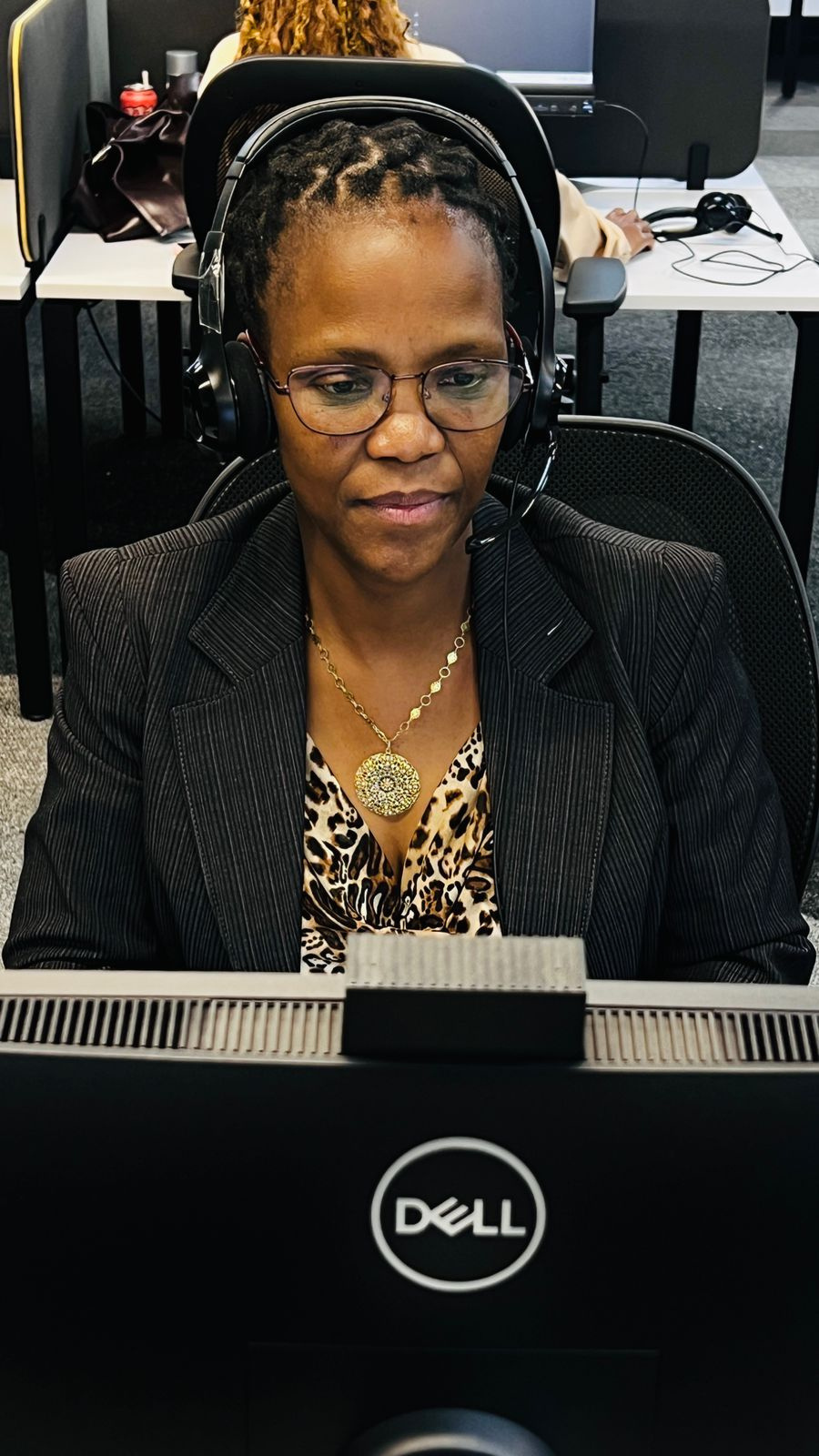 Spero agent on a headset taking a call at her workstation
